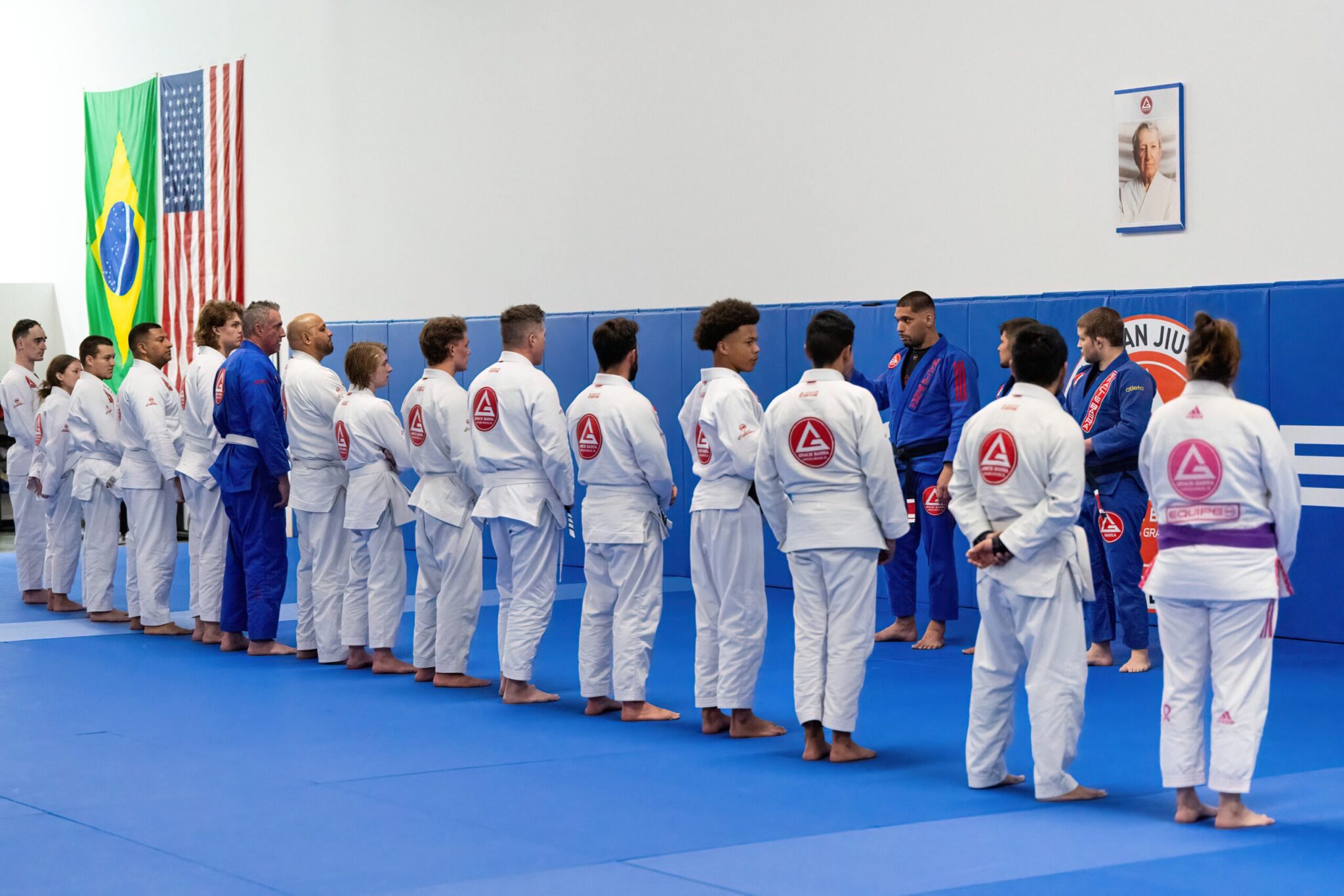 Adults lined to hear instructions from Professor Seidler Rodrigo at Gracie Barra West Jordan in Utah.