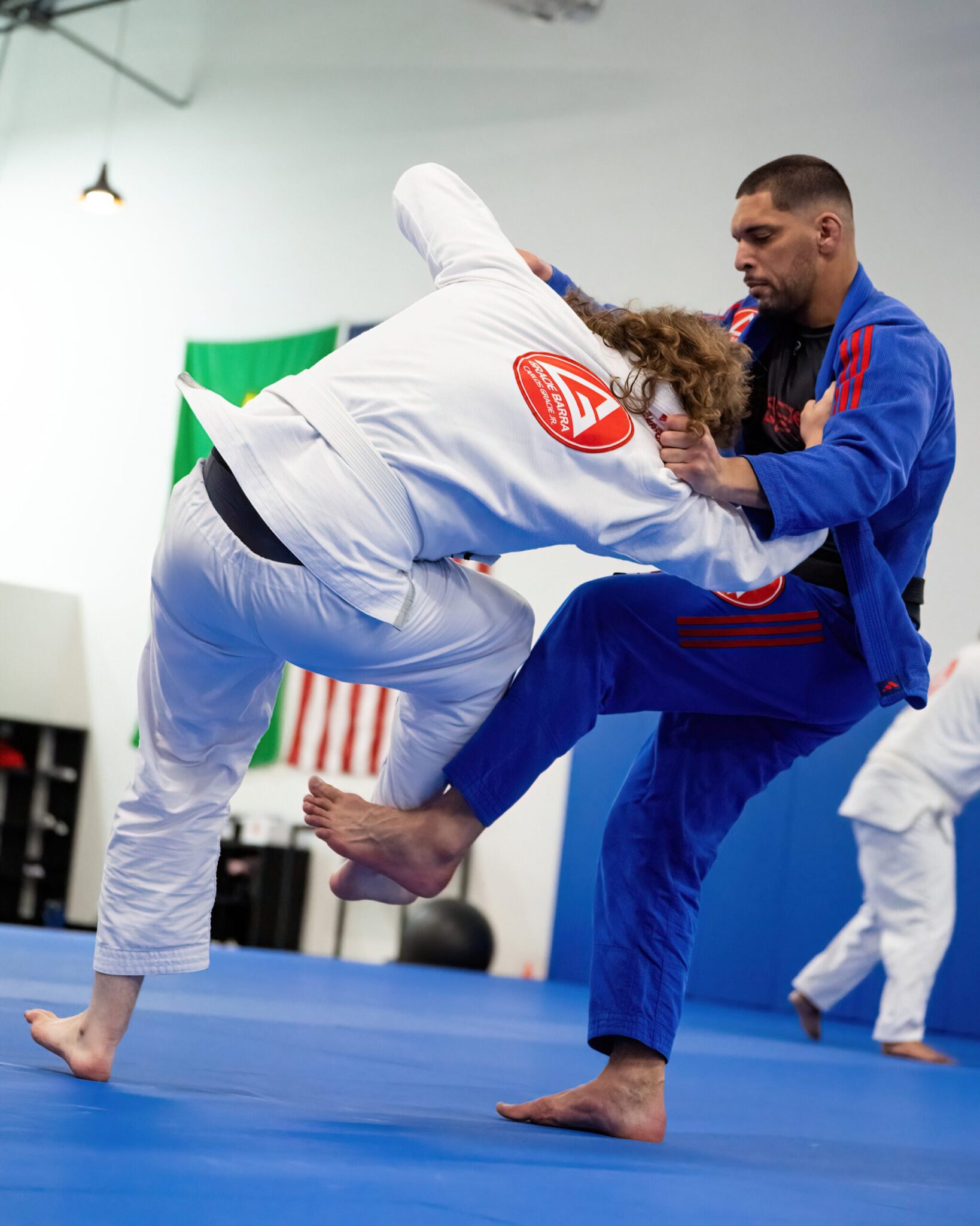 Professor Seidler Rodrigo practicing BJJ with a student at Gracie Barra West Jordan